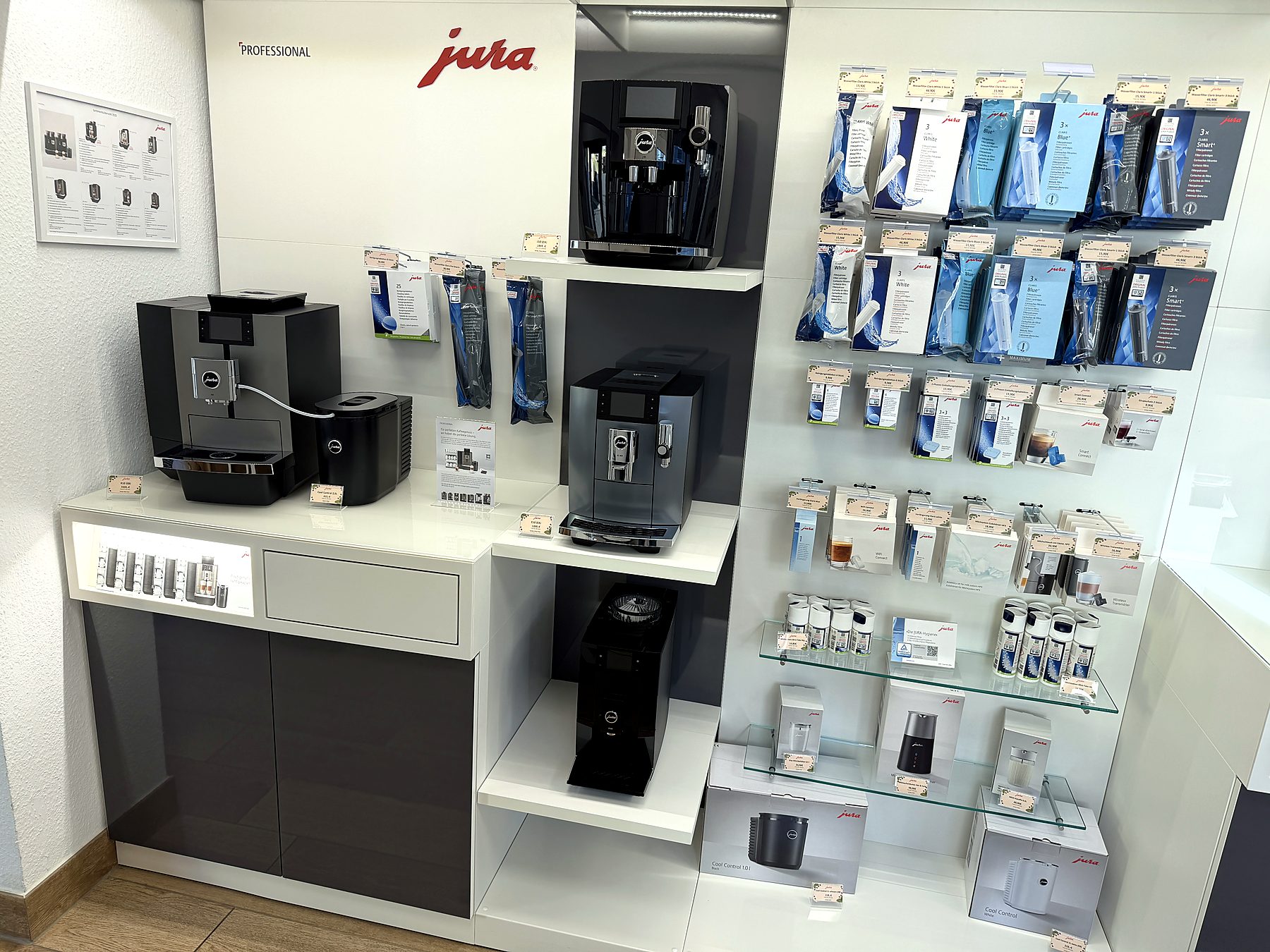 JURA Ausstellungswand mit Kaffeevollautomaten und Pflegeprodukten